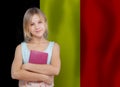 Pretty smiling teen girl student on Belgian flag background. Education and school in Belgian concept Royalty Free Stock Photo