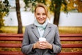 Pretty smiling woman with blonde hair holding cup of drink Royalty Free Stock Photo