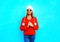 Pretty smiling woman with lollipop in red knitted sweater Royalty Free Stock Photo