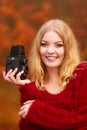 Pretty smiling woman with old vintage camera.