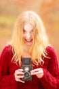 Pretty smiling woman with old vintage camera.