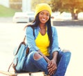 Pretty smiling young african woman with skateboard Royalty Free Stock Photo