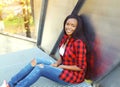 Pretty smiling young african woman wearing a red checkered shirt Royalty Free Stock Photo