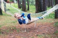 Pretty smilling boy resting on hammok in forest Royalty Free Stock Photo