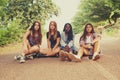 Pretty soon they ran out of things to do...Four young girls sitting in a road looking bored and displeased.