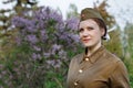 Soviet female soldier in the form of the Second World war against the background of lilac Royalty Free Stock Photo