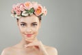 Pretty spa woman with clear skin and tender rose flowers portrait