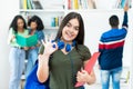 Pretty spanish female student with group of students