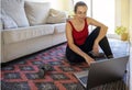 Pretty spanish girl practice online gymnastics at home in the living room and doing a pause