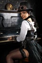 Pretty steampunk girl playing the piano