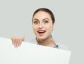 Pretty student girl having fun and holding white empty signboard background with copy space. Young businesswoman smiling Royalty Free Stock Photo