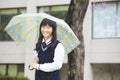 Pretty student girl holding umbrella in the rain Royalty Free Stock Photo