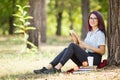 Smart student lady reading books and relaxing on a park background. Education concept. Copy space. Royalty Free Stock Photo