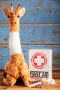 Pretty stuffed toy giraffe with bandaged neck Royalty Free Stock Photo