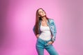 Pretty stylish happy young woman with lovely smile in stylish youth blue jeans clothes posing and positive smiling near vintage Royalty Free Stock Photo