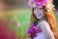 Pretty summer girl with crown of flowers