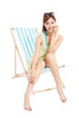 Pretty sunshine girl smiling and sitting on a beach chair Royalty Free Stock Photo