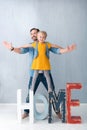 Pretty sweet girl standing on the huge wooden letters