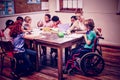 Pretty teacher helping pupils in classroom