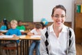 Pretty teacher smiling at camera at top of classroom Royalty Free Stock Photo