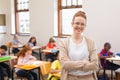 Pretty teacher smiling at camera at top of classroom Royalty Free Stock Photo