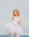 Pretty teen girl. Cupid cute angel with bow and arrows. Pretty white little girl as the cupid with a bow and arrow Royalty Free Stock Photo