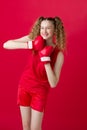 Pretty teen girl fighting with red boxing gloves