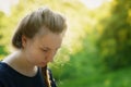 Pretty teen girl looking down and thining about something in park Royalty Free Stock Photo