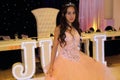 Pretty teen quinceanera birthday girl celebrating in princess dress pink party, special celebration of girl becoming woman. Royalty Free Stock Photo