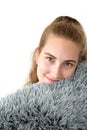 Pretty teenage girl cuddling with pillow