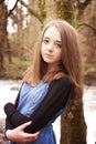 Pretty teenage girl leaning against a tree Royalty Free Stock Photo