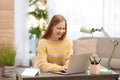 Pretty teenage girl using laptop at table Royalty Free Stock Photo