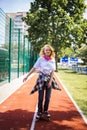 Pretty Teenage Girl Wearing Roller Skaters On The Road In Summe Park.