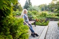 Pretty teenage girl 14-16 year old with curly long blonde hair and in glasses in the green park in a summer day outdoors. Royalty Free Stock Photo