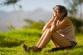 Pretty teenage hispanic girl sitting on grass Royalty Free Stock Photo