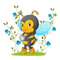 The pretty teenager bee is standing in the beautiful garden with the flowers ornament Royalty Free Stock Photo