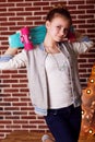 Pretty teenager girl is holding blue skateboard