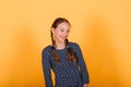 Pretty teenager girl smiling on camera looking cheerful on yellow background. Positive emotions Royalty Free Stock Photo