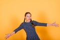 Pretty teenager girl smiling on camera looking cheerful on yellow background. Positive emotions Royalty Free Stock Photo