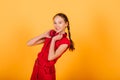 Pretty teenager girl smiling on camera looking cheerful on yellow background. Positive emotions Royalty Free Stock Photo