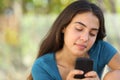 Pretty teenager girl texting in a smart phone Royalty Free Stock Photo