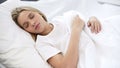 Pretty teenager sleeping in bed, healthy relaxation, clean bedclothes in hotel Royalty Free Stock Photo