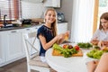 Pretty teenagers making a gamburger in the kitchen Royalty Free Stock Photo