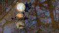 Pretty terrestrial globe in wood and metal, placed in a puddle outside, and its reflection