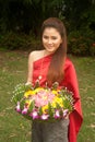 Pretty Thai woman hold flower joist. Royalty Free Stock Photo