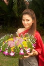 Pretty Thai woman hold flower joist. Royalty Free Stock Photo