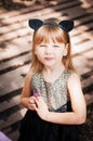 Pretty three year old girl in a cat costume, with a flower in her hand. Royalty Free Stock Photo