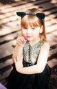 Pretty three year old girl in a cat costume, with a flower in her hand. Royalty Free Stock Photo