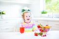Pretty toddler girl having breakfast drinking juice Royalty Free Stock Photo