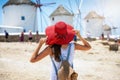 Woman enjoys the view to the famous windmills in Mykonos island, Cyclades, Greece Royalty Free Stock Photo